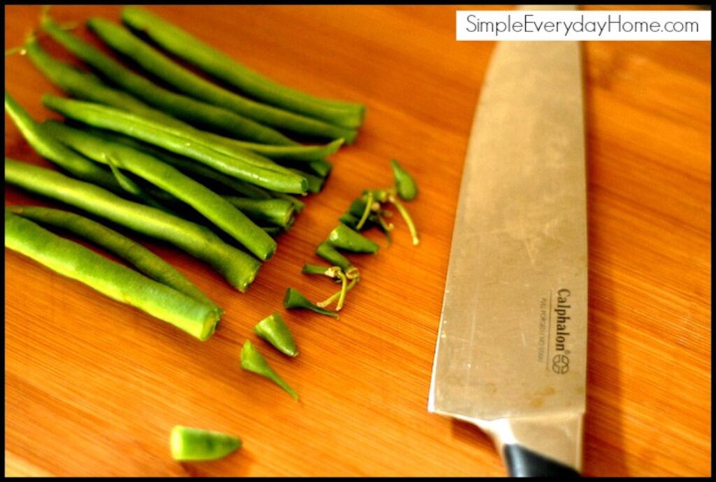 Green beans on a cutting board with knife