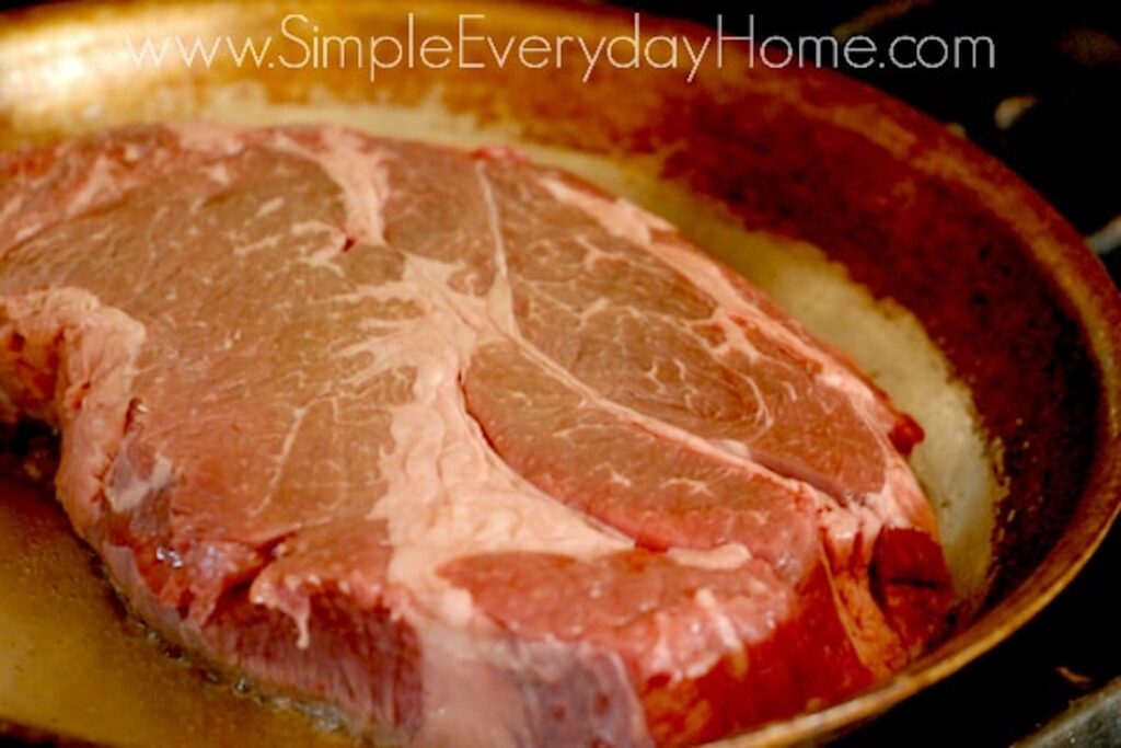 Beef roast cooking in skillet