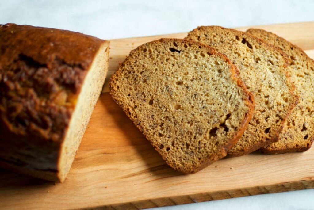 Sliced banana bread on wooden board