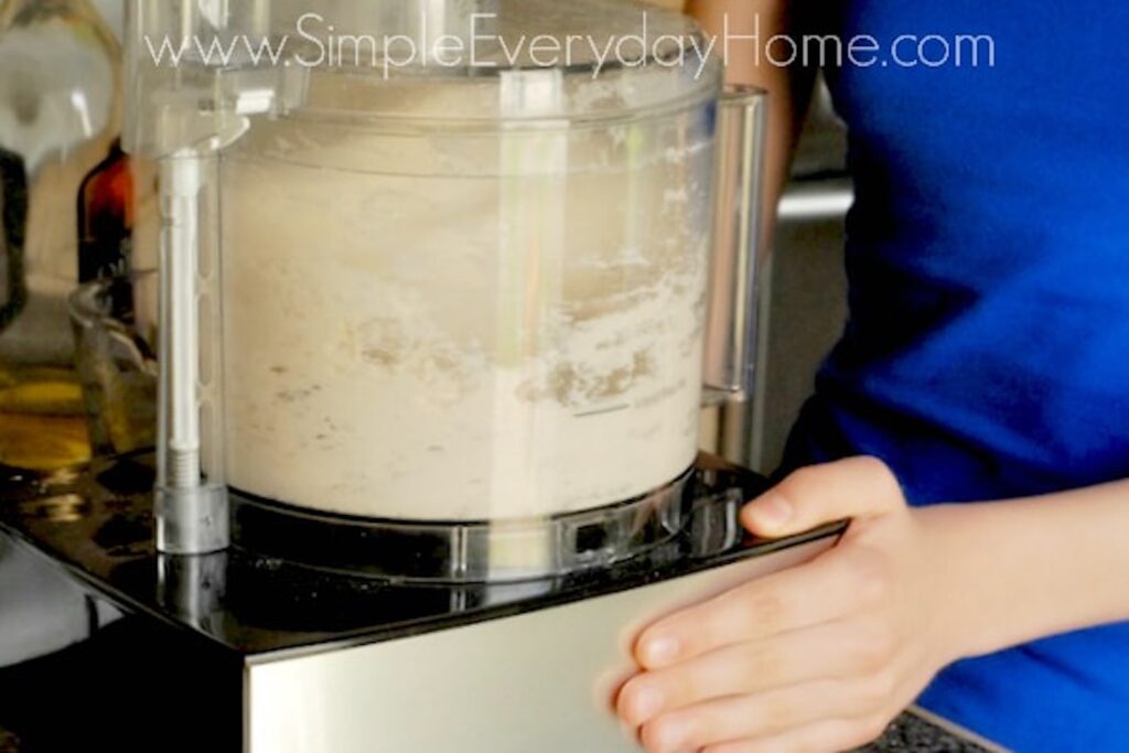 A food processor mixing bread dough