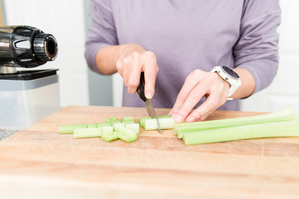 A woman chopping celery