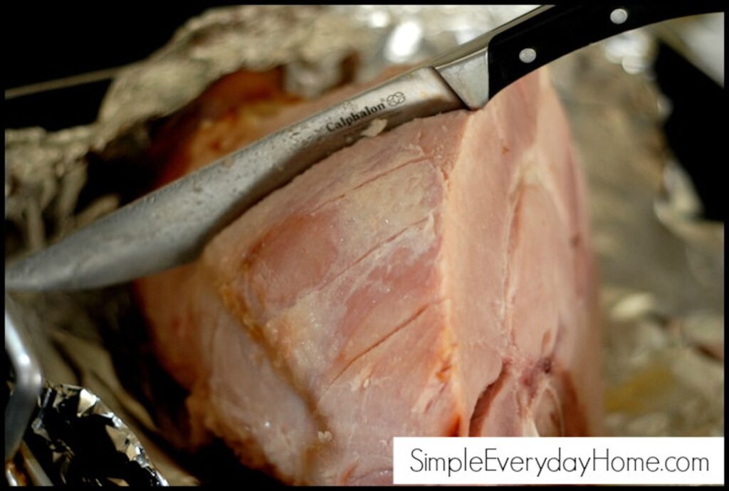 Ham being scored with knife