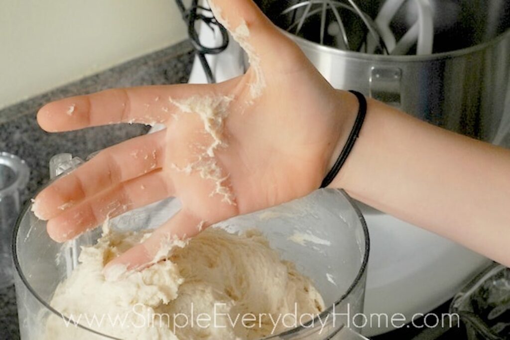 Bread dough sticking slightly to hand