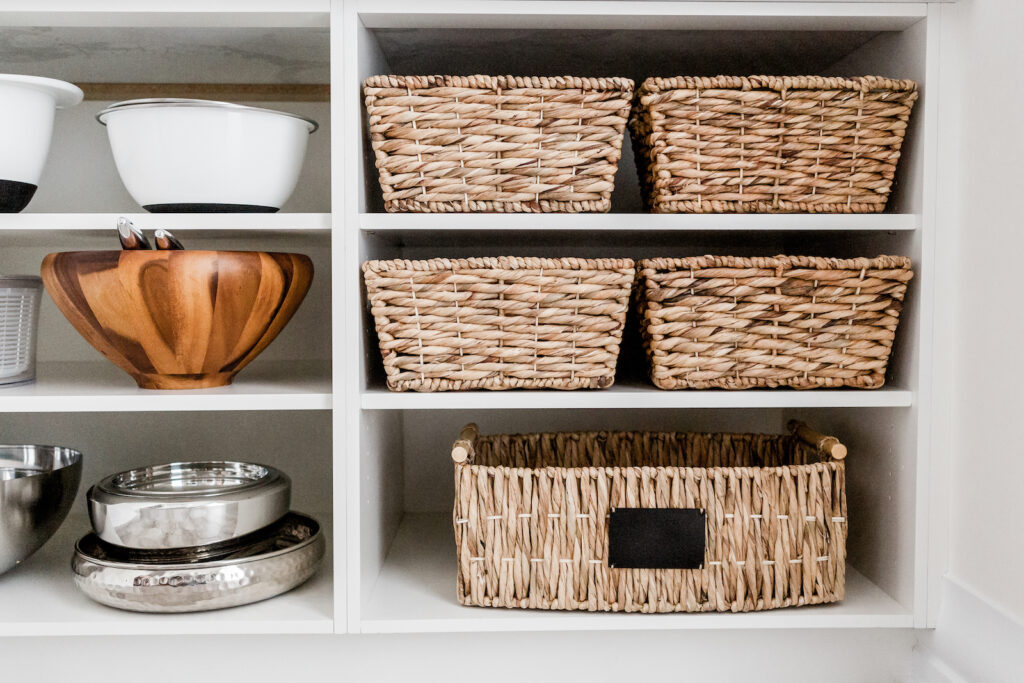 Baskets and dishes on white shelves
