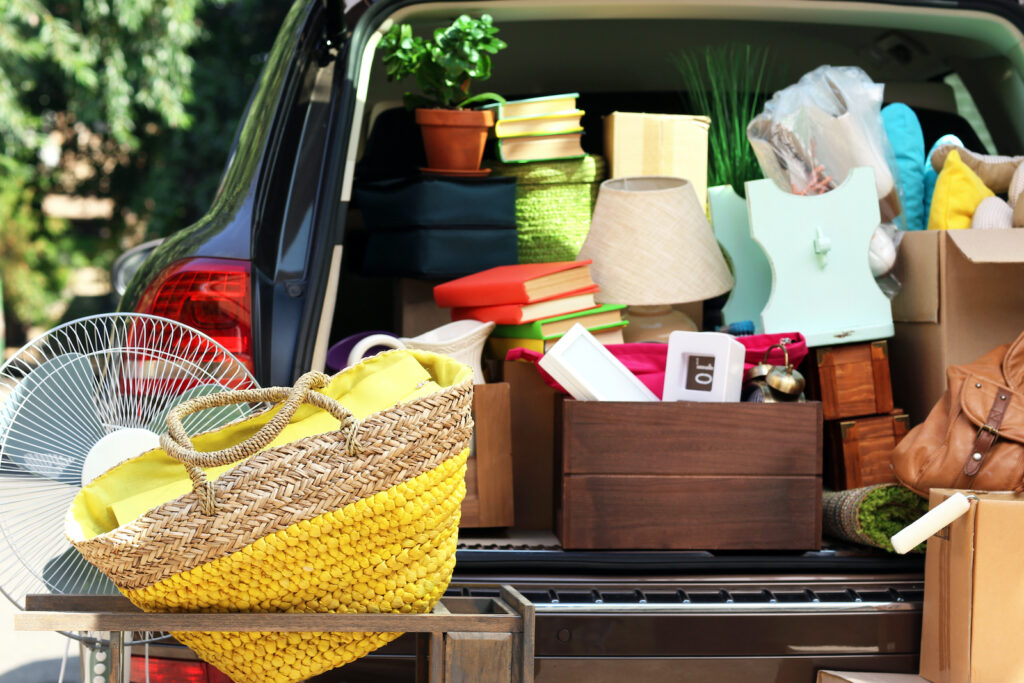 back of a car loaded with books and boxes to get rid of