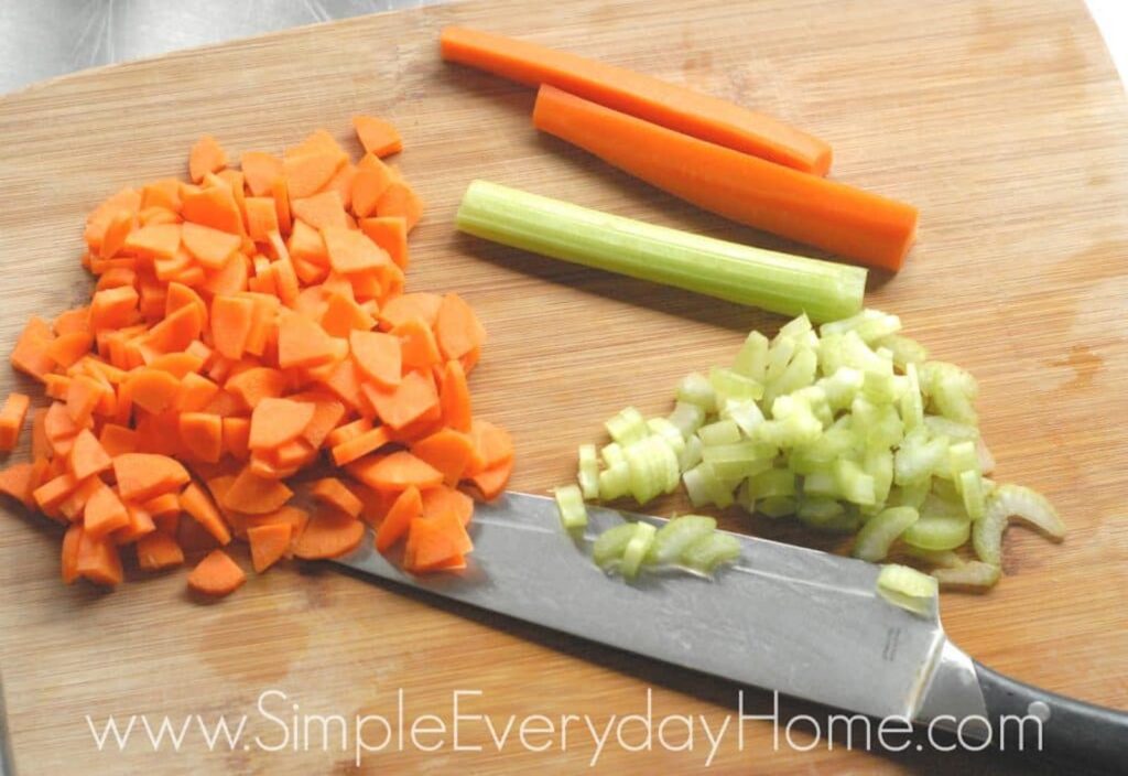 Carrots and celery diced on cutting board