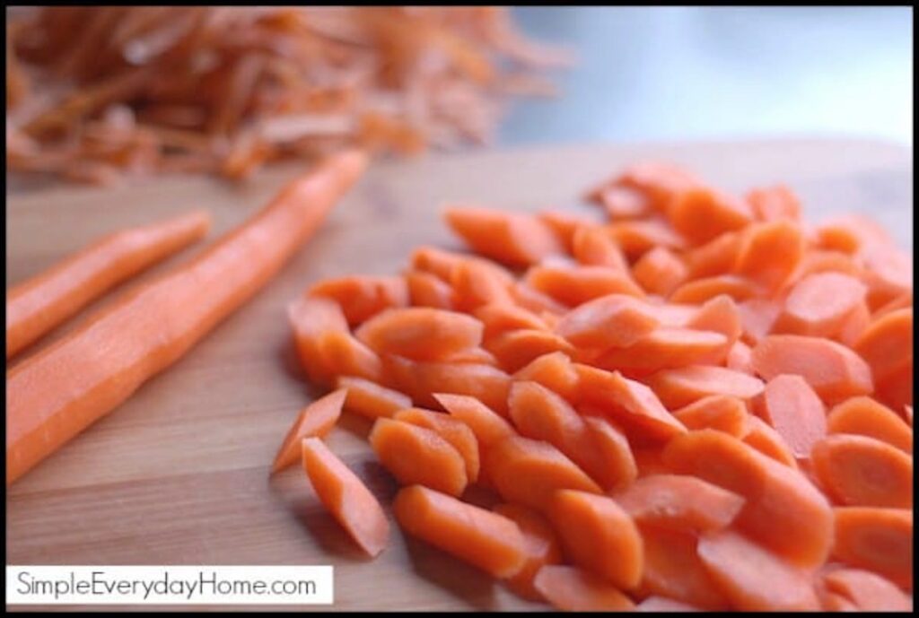 Sliced raw carrots on a cutting board
