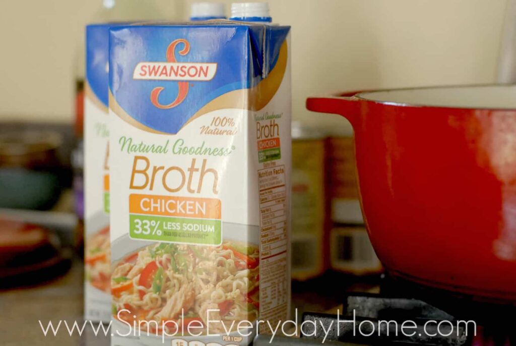 Carton of chicken broth setting beside stove